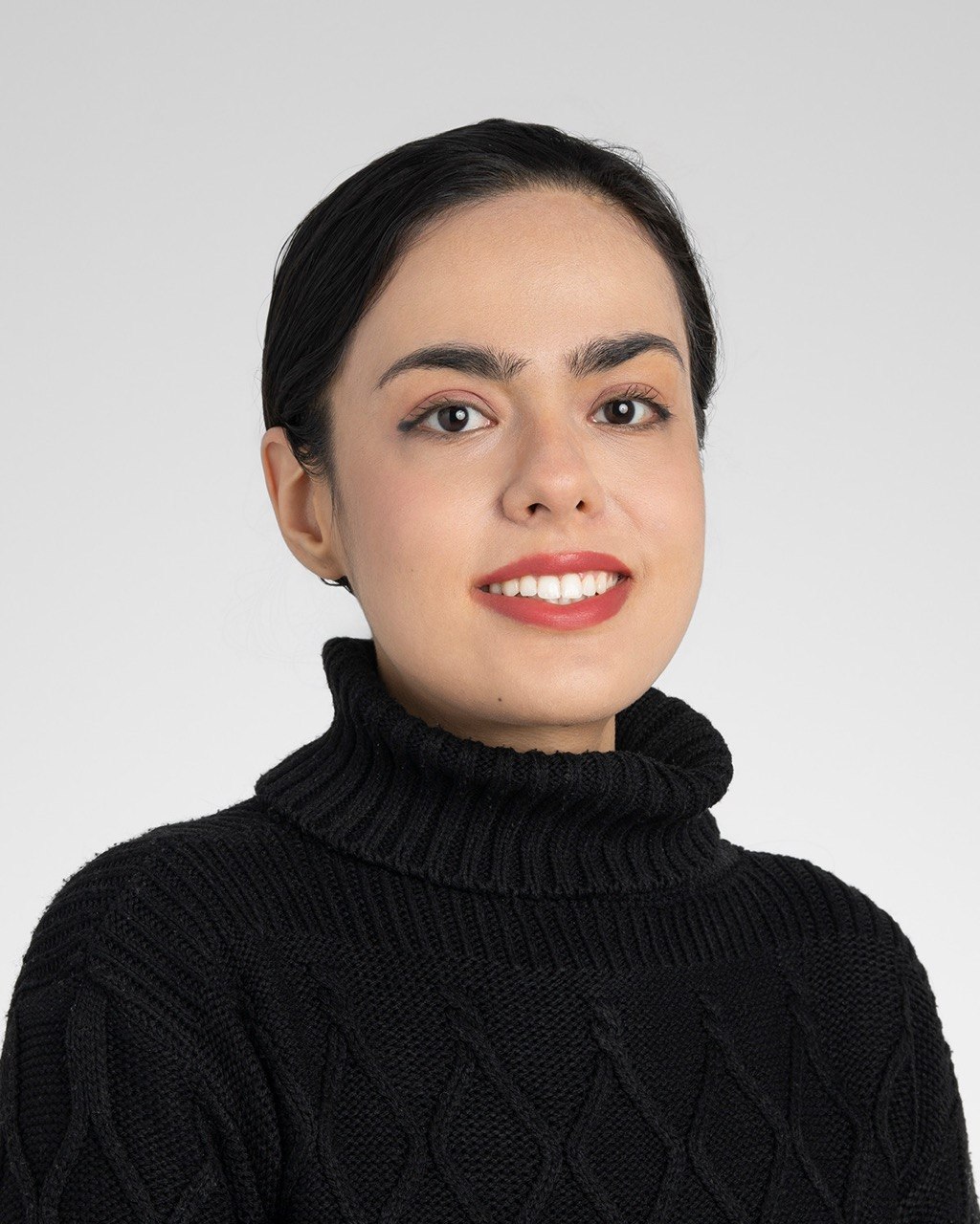 Photo of young woman with strong eyebrows, black hair, and red lips