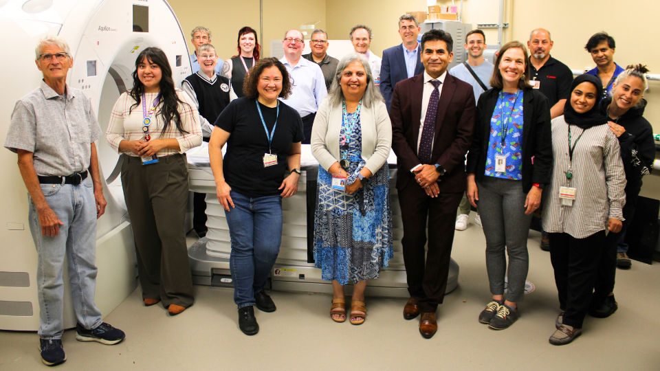 A group celebrates the ribbon cutting at the King County Medical Examiner's Office in celebration of their new CT scanner.