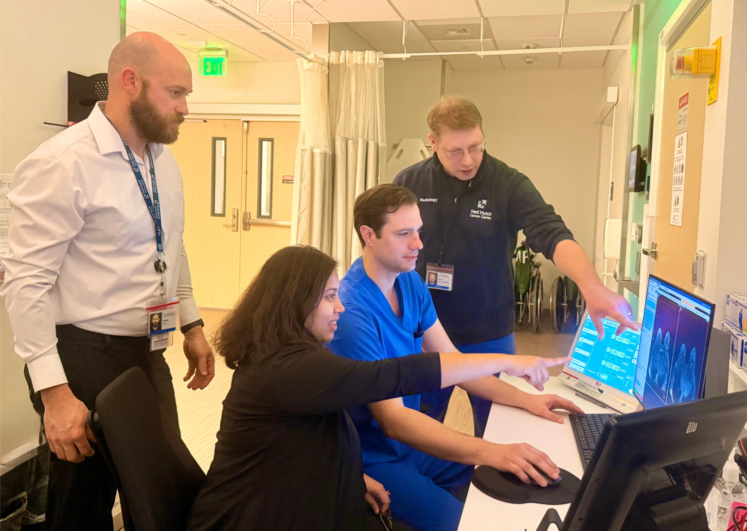 Researchers Dallas Turley, PhD, Debosmita Biswas, MS, Michael Senff, RT(R)(MR)MRSO, and Kevin Widner (left to right) review high-resolution breast MRI scans as part of an ongoing research collaboration.