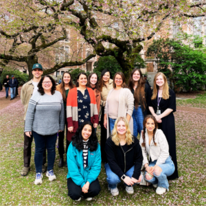 Kleinhans Lab members take a photo together under a Sakura Tree.