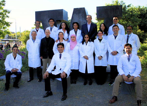 Male and female doctors in white labcoats sitting and standing.